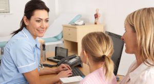 NHS nurse with patient and child